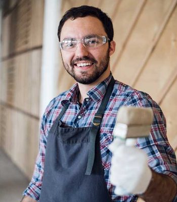 Artist decorating the boy's room with blue paint. Home during renovation, decoration and painting. Interior apartment improvement maintenance. Roller, ladder for house repair